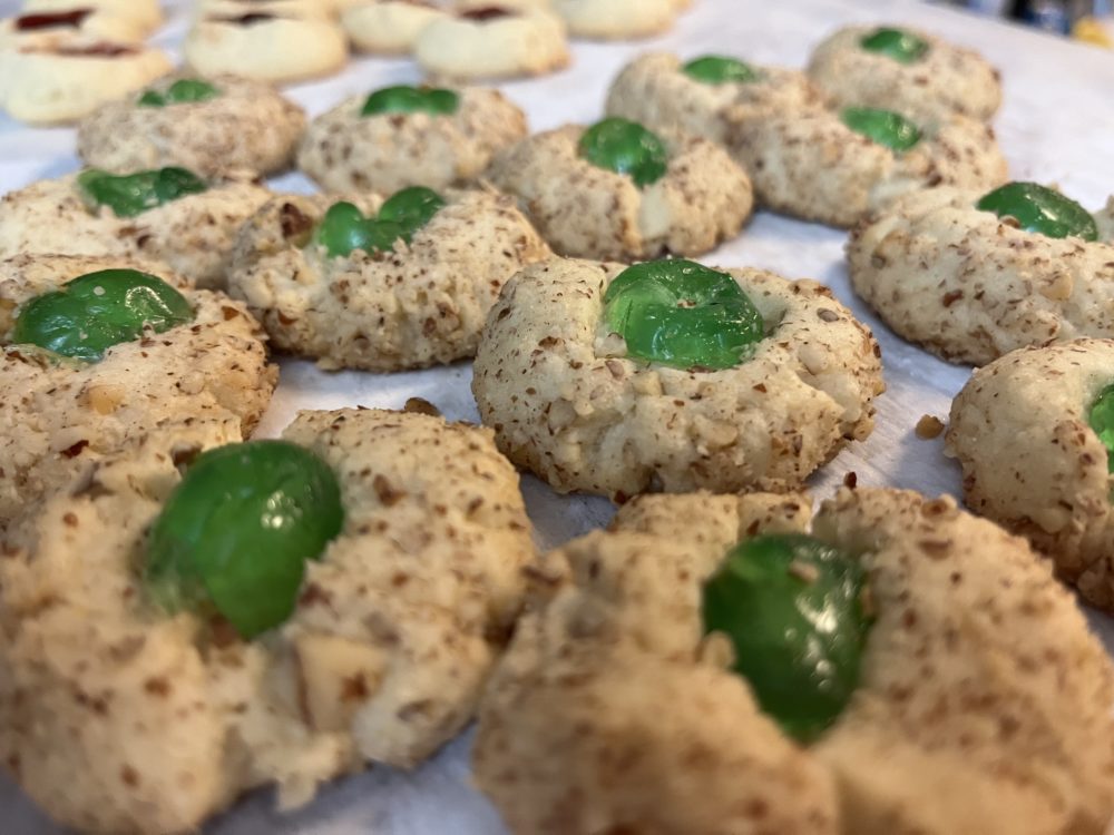 Thumbprint Christmas cookies with a candied cherry